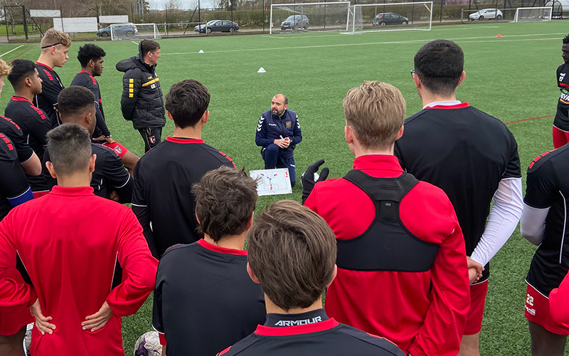 Coach Fran Constancio leads a team talk 